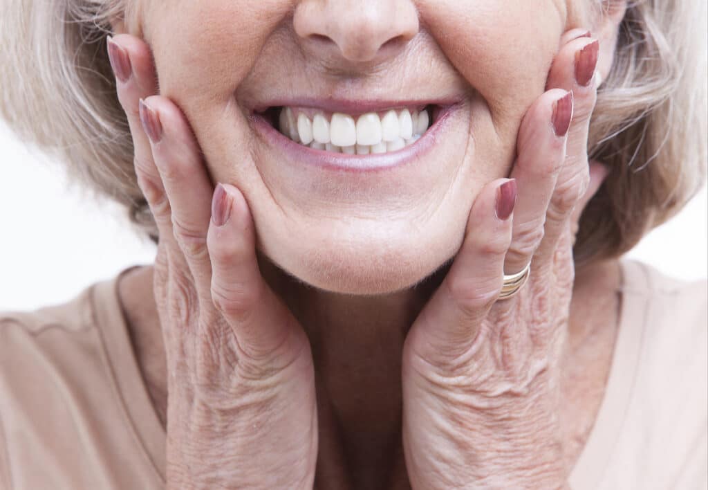 Female smiling wearing her custom dentures