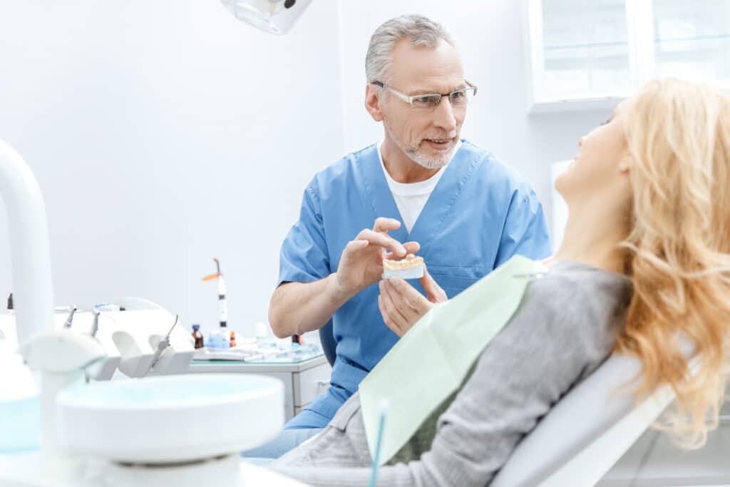 Dentist discussing deep cleanings and dental insurance