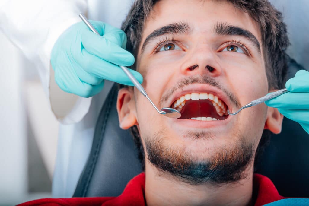 Patient being examined for the need of a filling