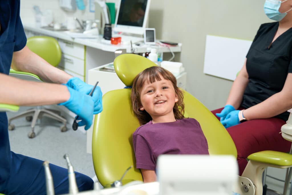 Pediatric dental patient sitting in the dental chair