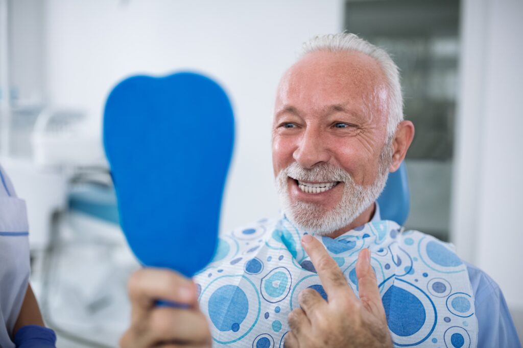Older gentlemen visiting the dentsit with a healthy smile