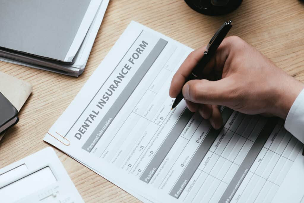 Dental patient filling out a dental insurance form