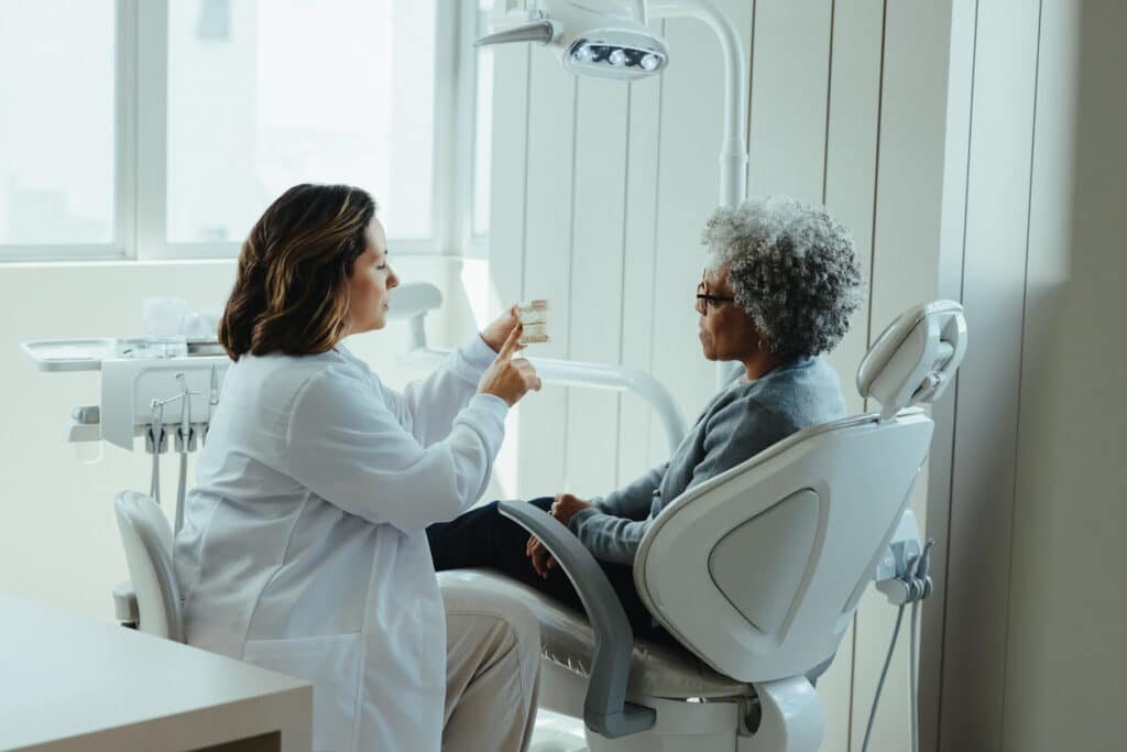 dental patient attending an appointment with the dentist discussing her smile